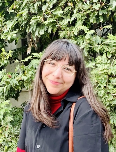 Beverly Conrique, Ph.D. in front of greenery